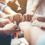 people putting their hands in a circle